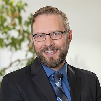 A professional headshot of Matthew Metyk 