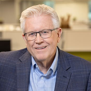 A professional headshot of Rick Peterson