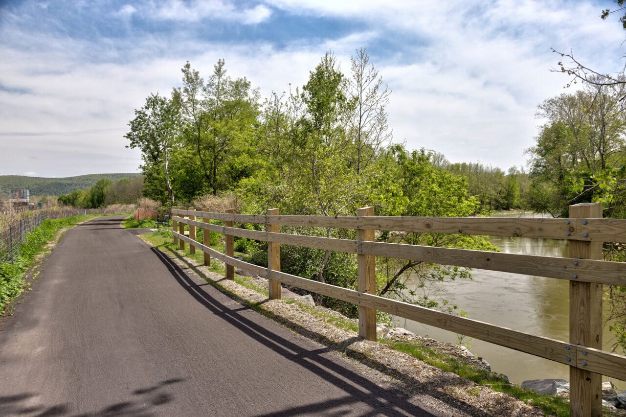 A photograph of a trail crossing a small body of water