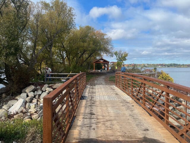 A photograph of a bridge leading to a pavilion