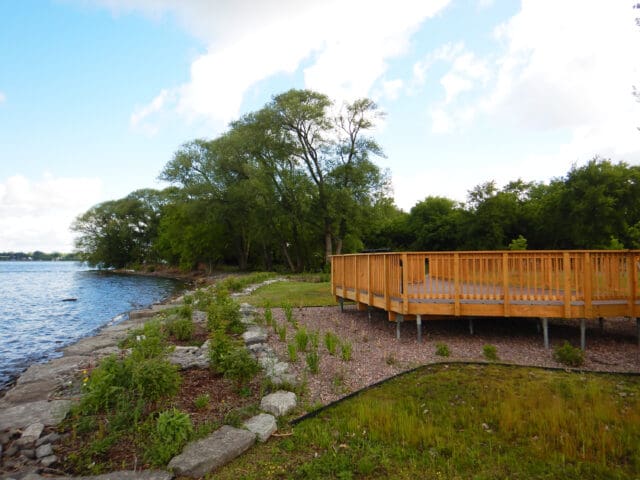 A photograph of a deck overlooking a stabilized shoreline