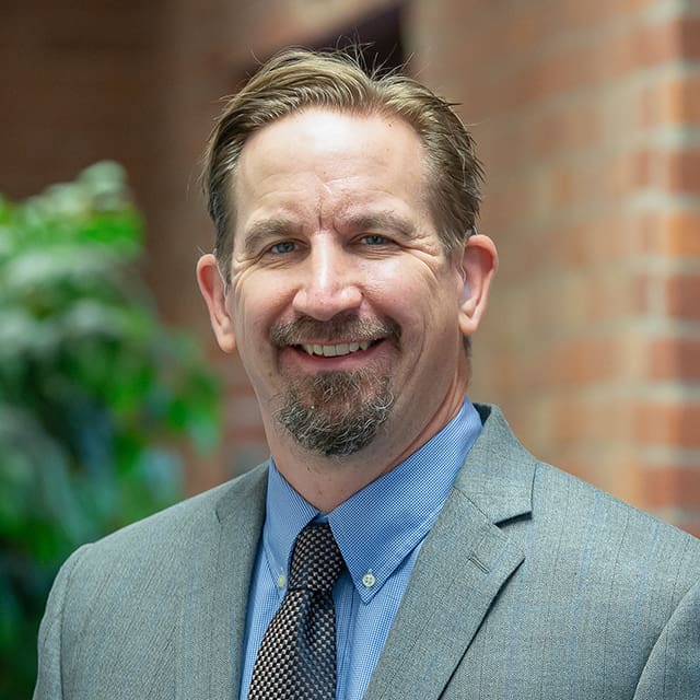 A professional headshot of Darren Pieters