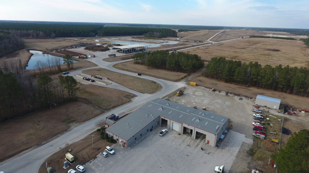 An aerial photograph of garages and offices at a landfill site