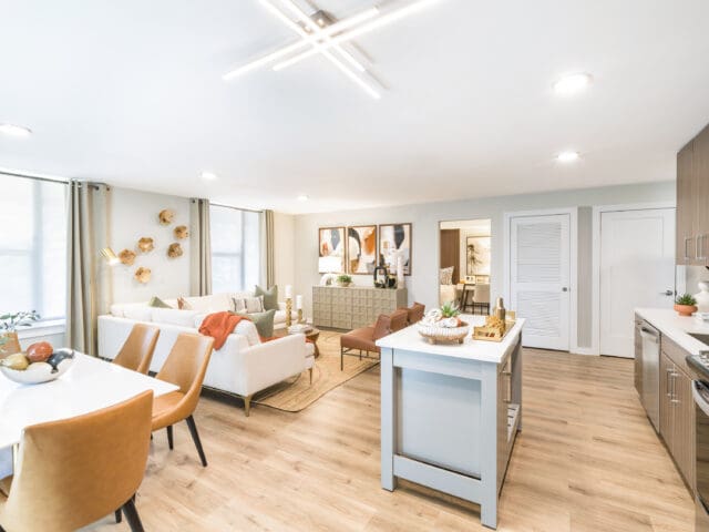 A photograph of a living room with modern, luxury furniture and fixtures.