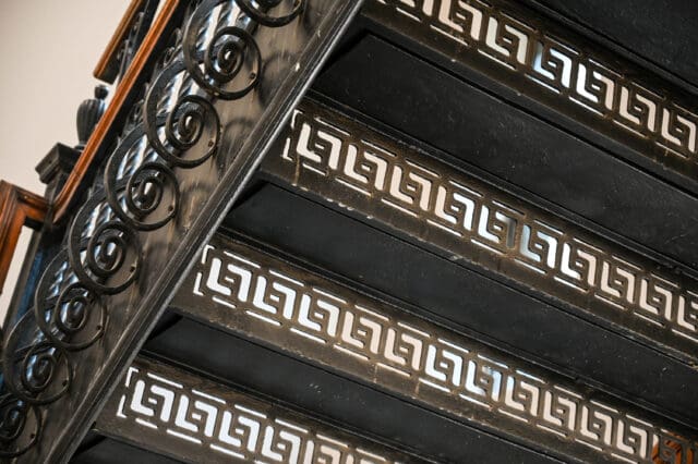 A detail photograph of highly intricate iron stairs.
