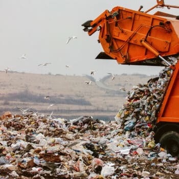 Garbage truck dumping the garbage on a landfill