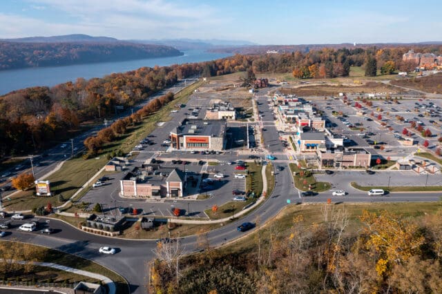 An aerial photograph of the Hudson Heritage plaza with remains of the former Hudson River Psychiatric Center in the back right (east) and the Hudson River on the left (west).