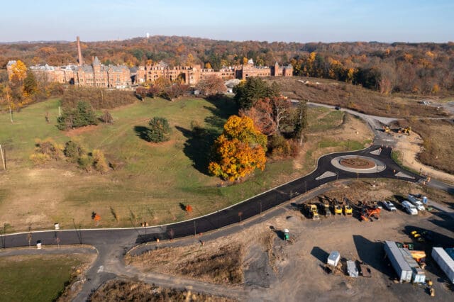 An aerial photograph of a traffic circle, remains of the former Hudson River Psychiatric Center, and room for development on the Hudson Heritage property