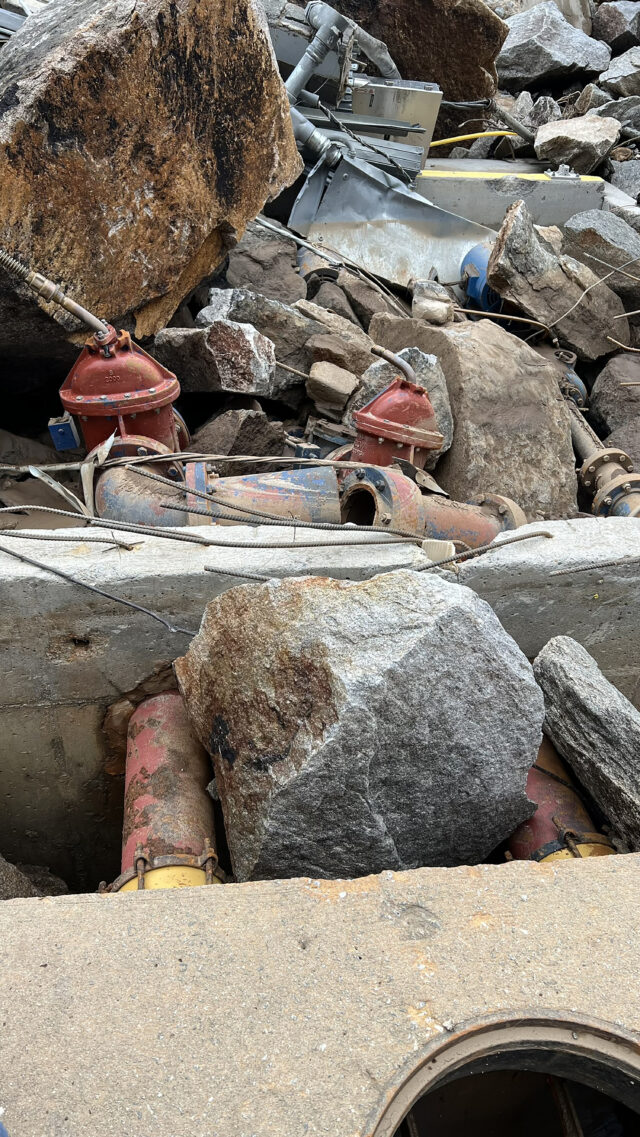 A photograph of a damaged piping and valves which were part of a pump station in Lake Lure, NC. following Hurricane Helene