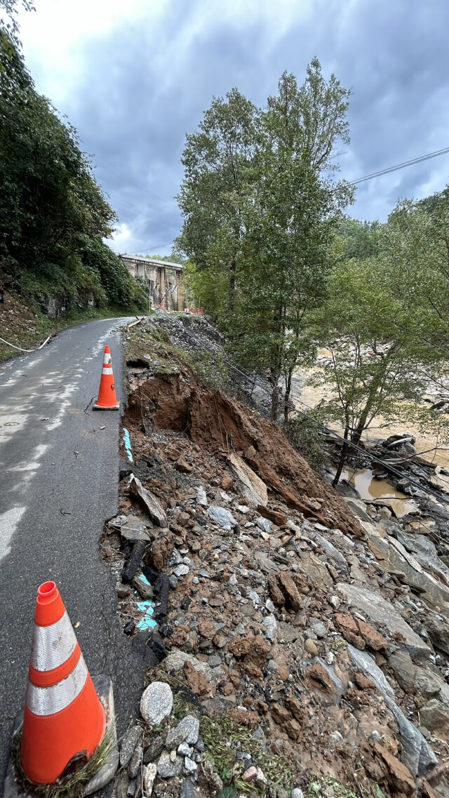 A photograph of a collapsed road in Lake Lure, NC. following Hurricane Helene