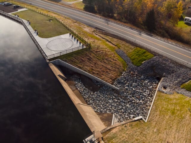 An aerial photograph of a dam and park along Lake Adirondack