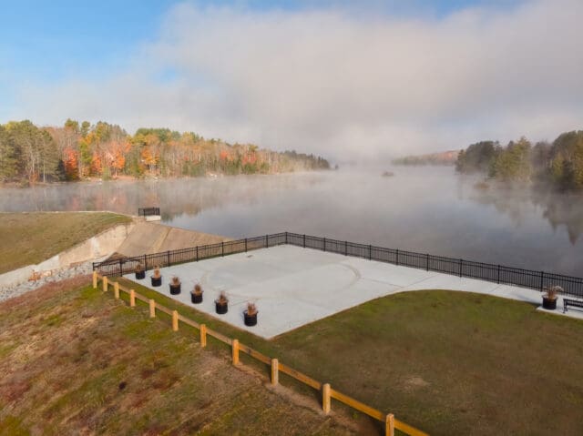 An aerial photograph of a park overlooking a body of water (Lake Adirondack)