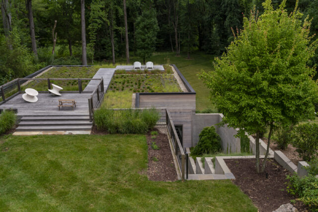 A photo of a green roof on top of a multi-level residence