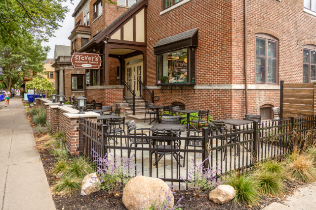 A photo of a stone patio and landscaping in front of Stever's Candies in Rochester