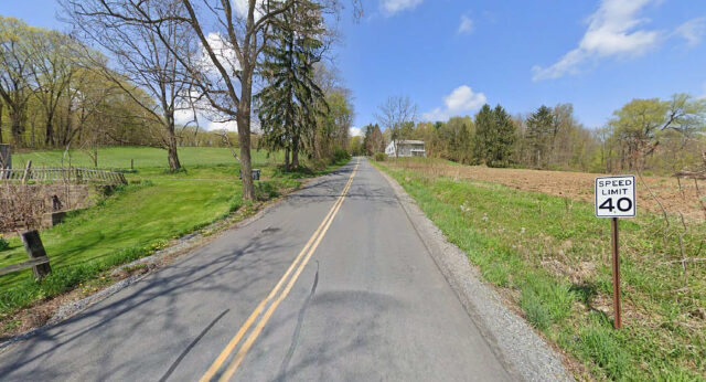 A road with no bicycle facilities and a narrow shoulder