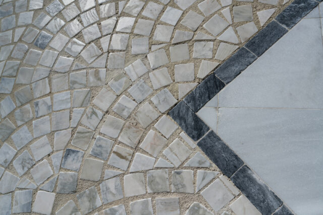 An up-close photograph of stone detail on a walkway