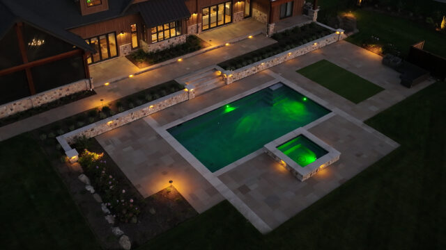 A nighttime photo highlighting custom lighting of an outdoor living space of a single-family home.