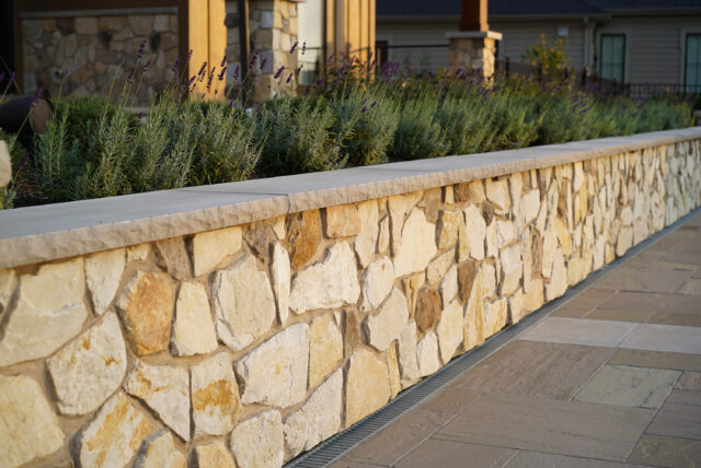 A photo of stonework and plantings as part of an outdoor living space