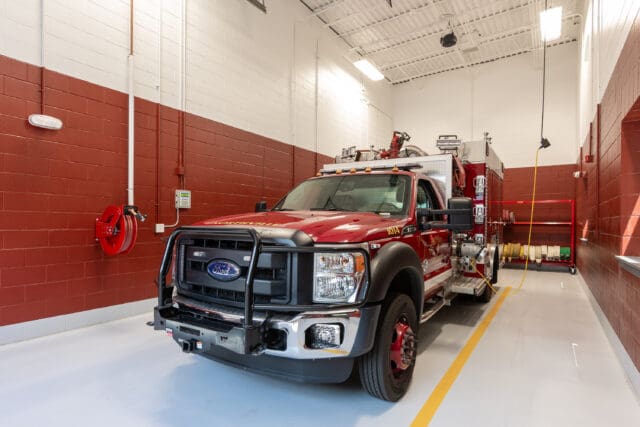 A photograph of a firetruck inside of a wash bay in the Great Sacandaga Lake Firehouse in Northville, NY