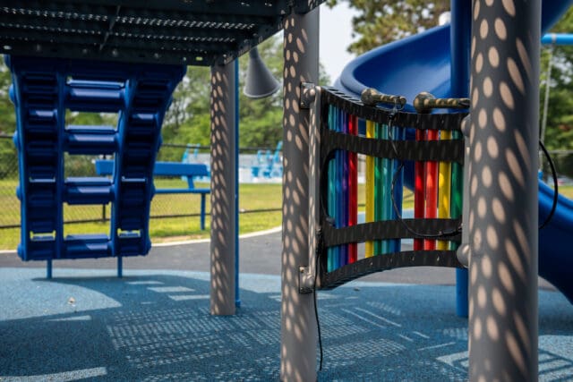 A photograph of a large xylophone instrument that is part of a playground set