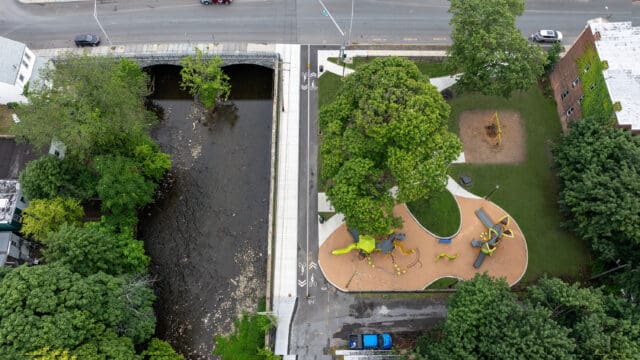 An aerial photograph of Canal Ave Park in Troy, NY, with a road and body of water to the left.