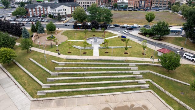 An aerial photograph of the William C. Chamberlain Riverfront Park, which shows two monuments, walking paths, and landscaping.