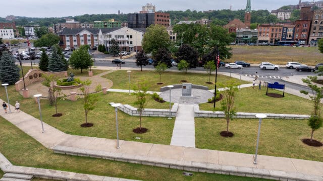 An aerial photograph of the William C. Chamberlain Riverfront Park, which shows two monuments, walking paths, and landscaping.