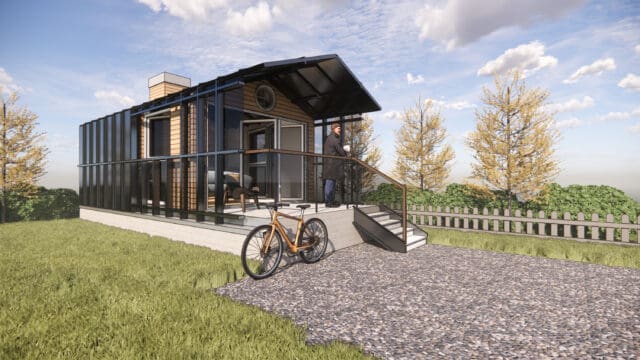 A photo-realistic simulation of a tiny home set in a rural setting, with a person standing on a front porch and a bicycle on the driveway.