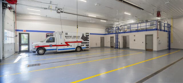 A photograph of ambulance bays with one ambulance parked inside.