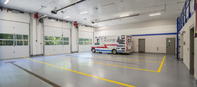 A photograph of the interior of ambulance bays with one ambulance parked