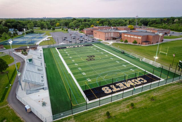 An aerial photograph of a multi-use turf field stadium.