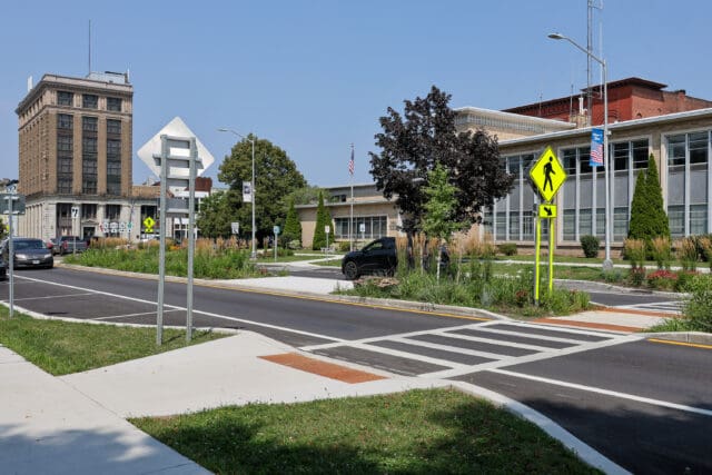 A photograph of a crosswalk to a landscape median
