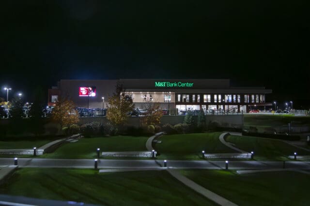 A nighttime photograph of the exterior of the M&T Bank Center Arena
