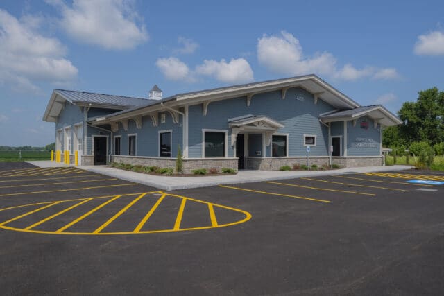 A photograph of an EMS station. It is a blue building.