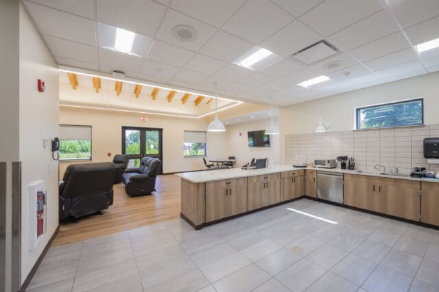 A photograph of an open-concept kitchen with mixed materials.