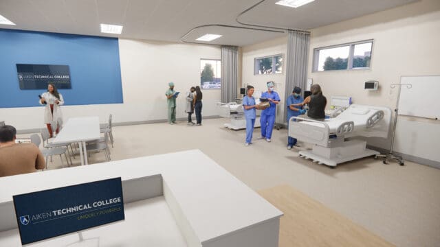 A simulation of a hospital environment in the future Nursing Education Center at Aiken Technical College. Nurses and doctors are meeting with patients. There are two hospital beds, a desk, a table with chairs, and a television.