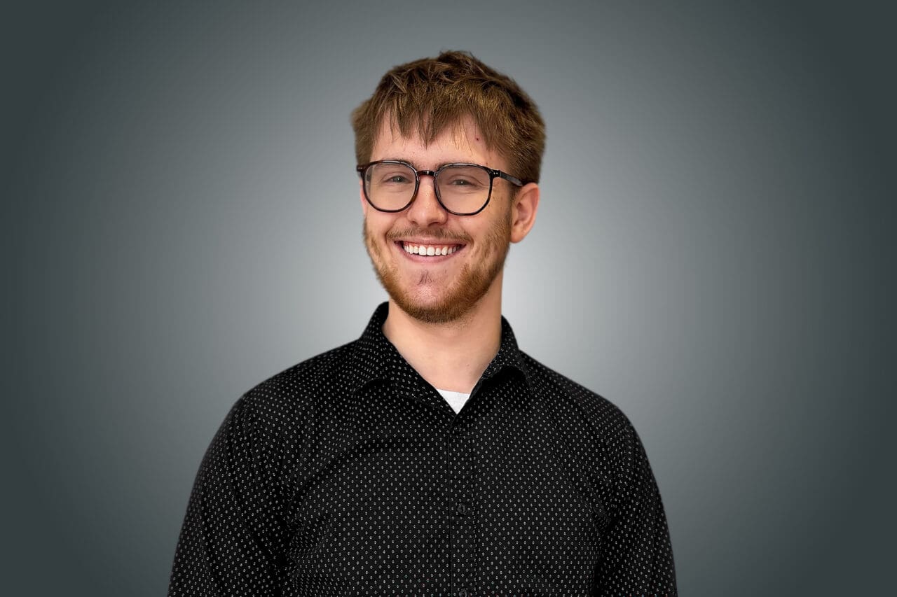 A professional headshot of Andrew Graham