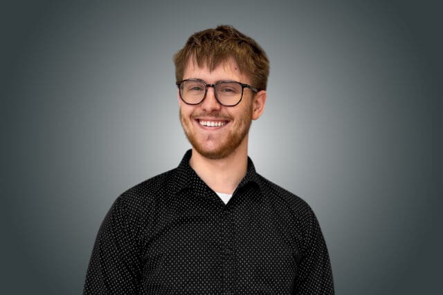 A professional headshot of Andrew Graham