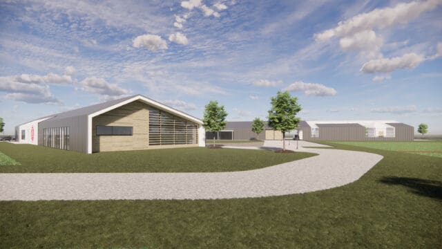 A simulation of a large building and greenhouse in an agricultural setting.