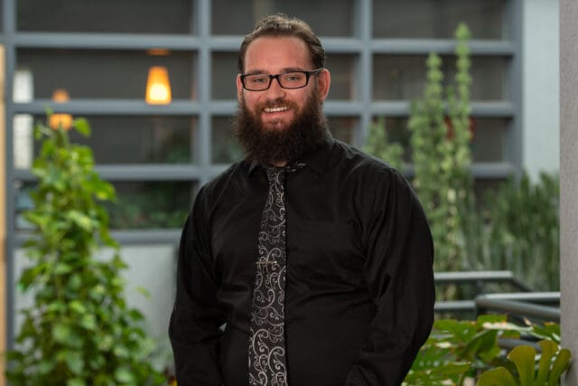 A professional headshot of Gabriel Monck-Zweck