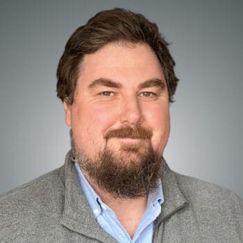 A professional headshot of Christopher Connolly