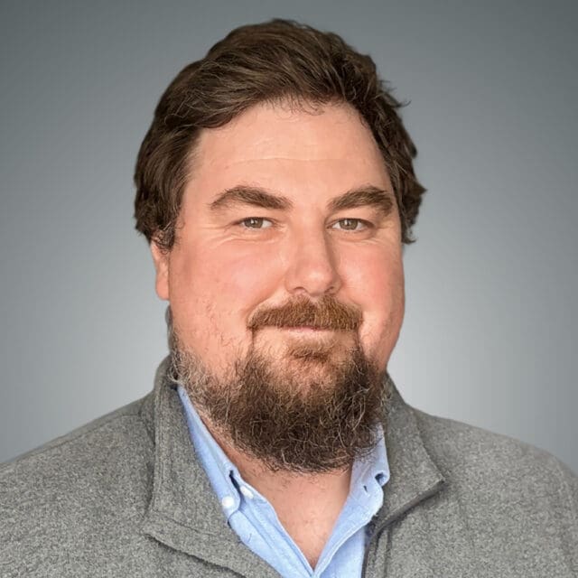 A professional headshot of Christopher Connolly