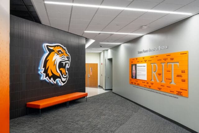 A photograph of the donor wall at Judson Stadium. There is a large tiger graphic across from it.