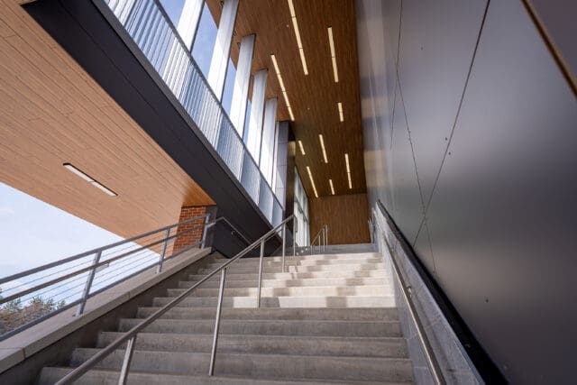 A photograph of a staircase with ample daylight shining in and mixed materials