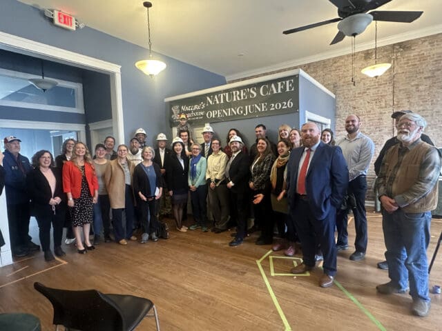 A photograph of a large group of people at a ceremony.