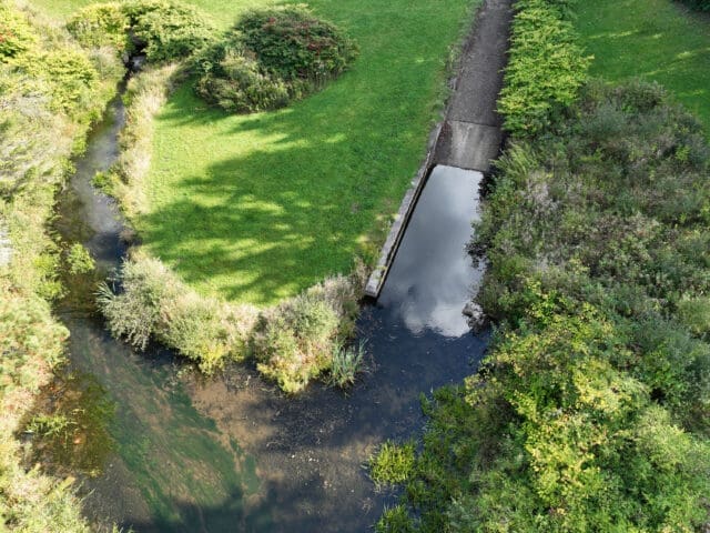 An aerial photograph of a dam spillway