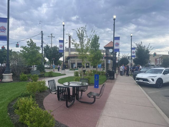 A photograph of a small park setting with a picnic table.